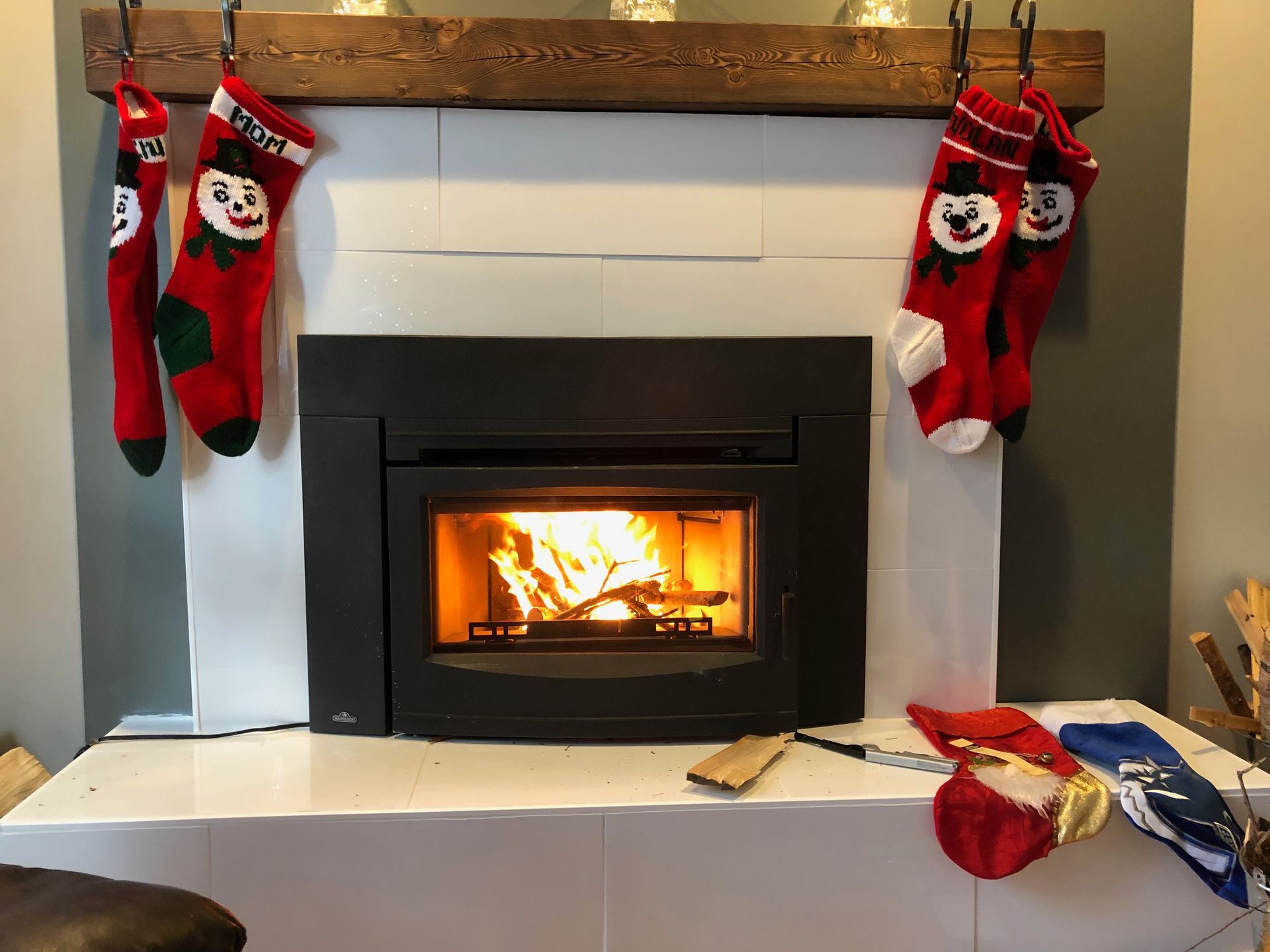A fireplace with christmas stockings hanging on the mantle.