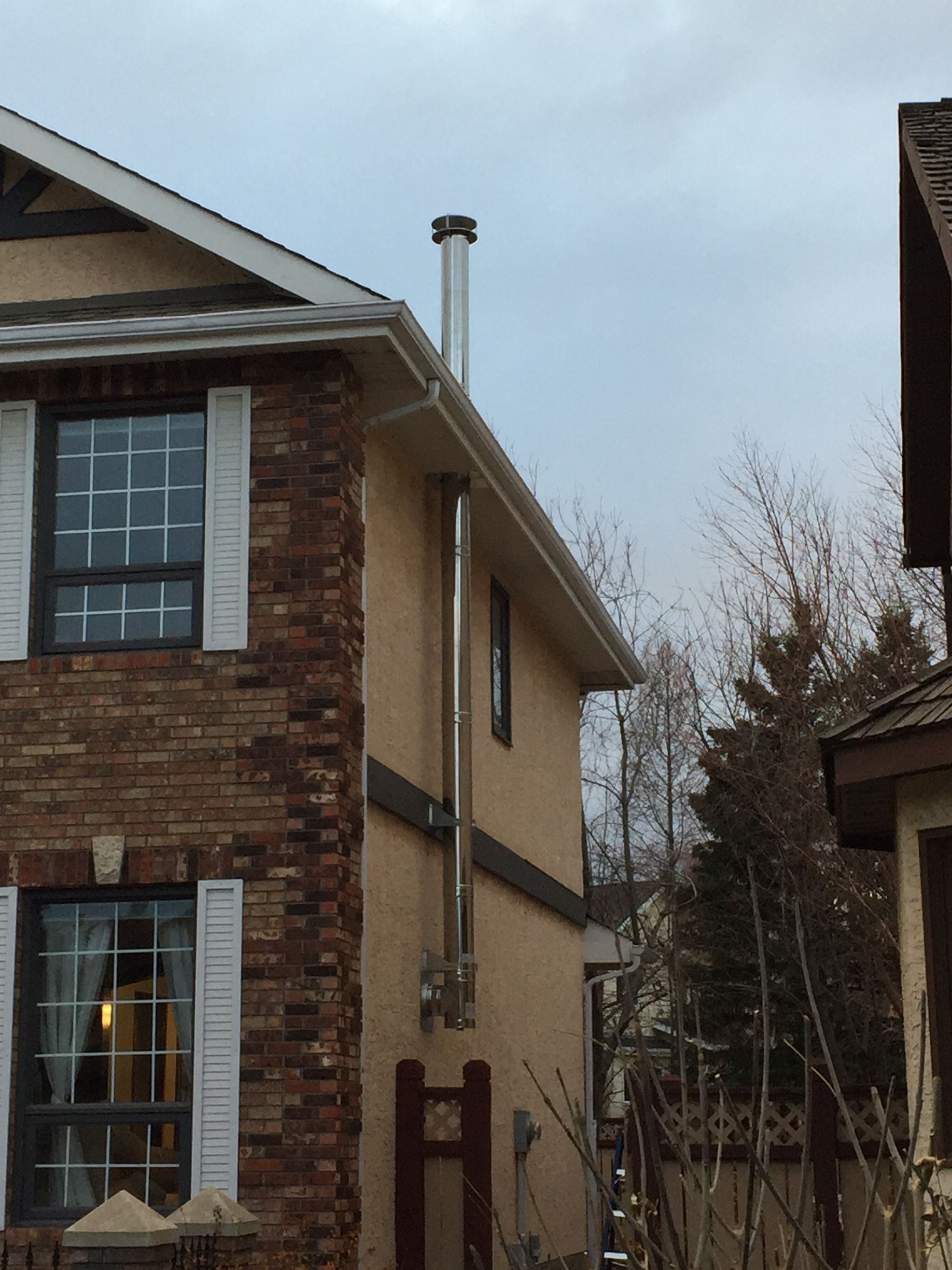 A house with a chimney on the side of it