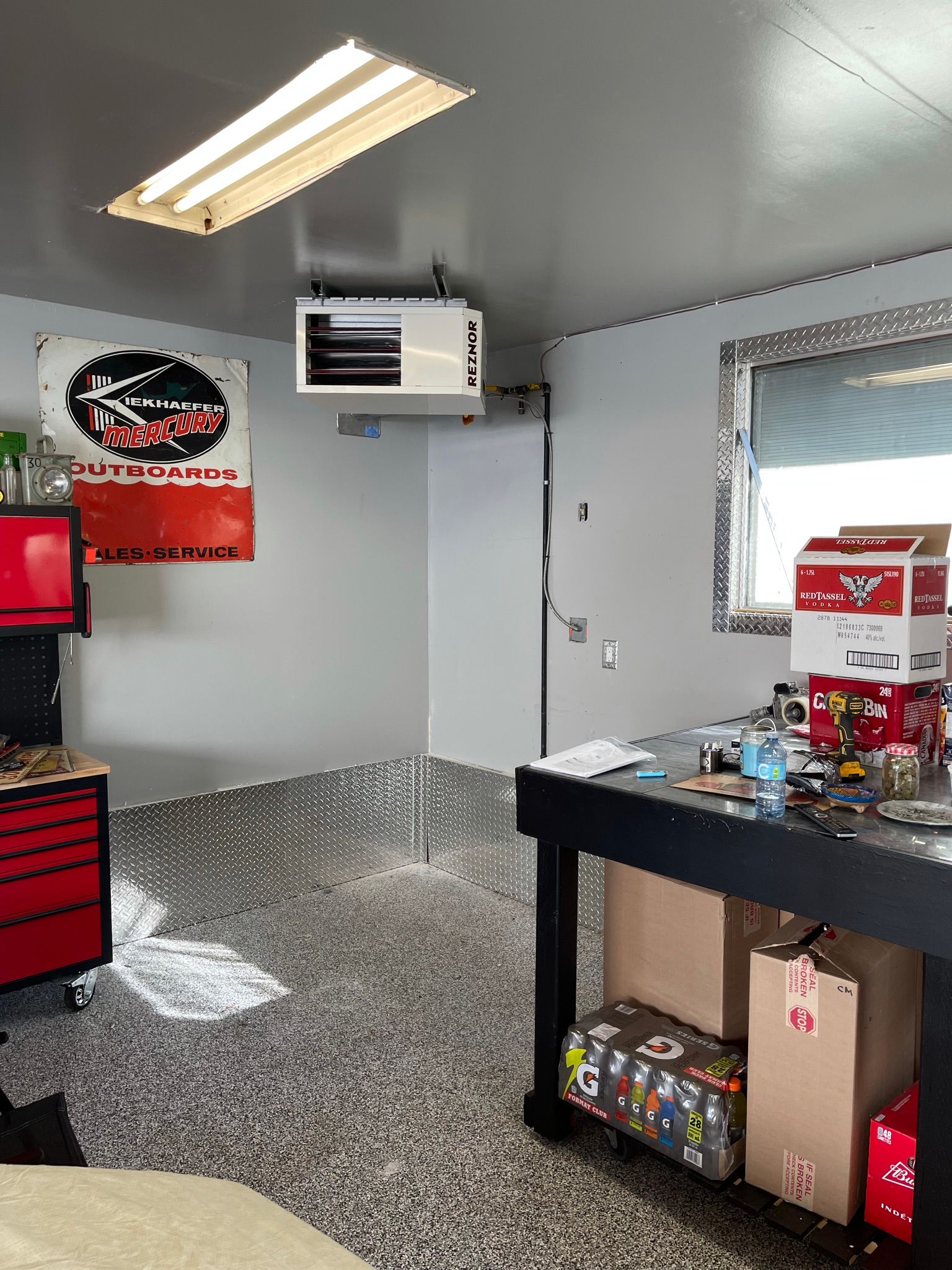 A garage with a table and a sign on the wall.