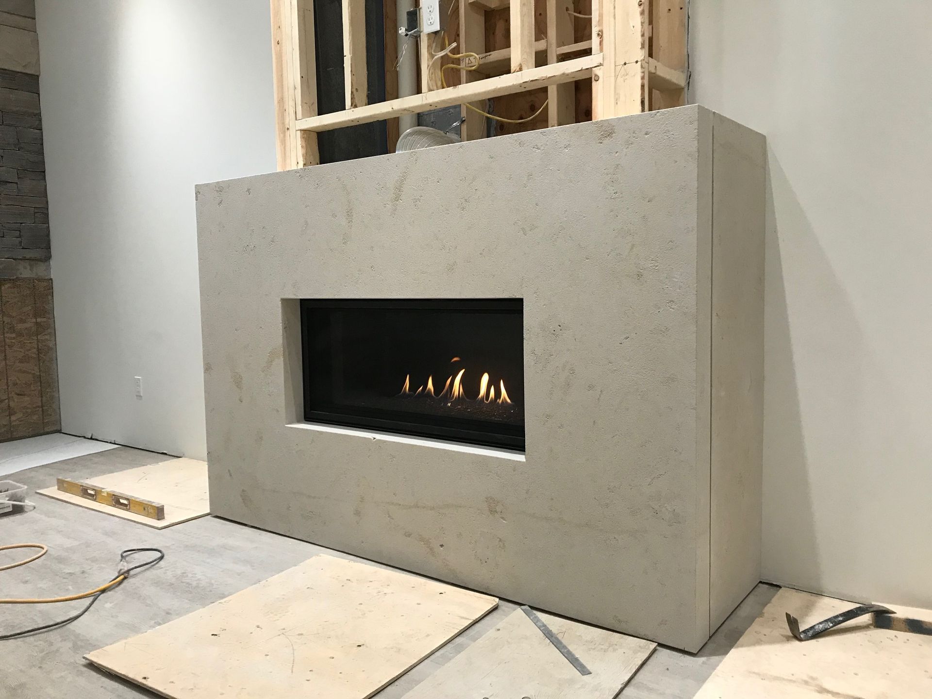A fireplace is being built in a room in a house.