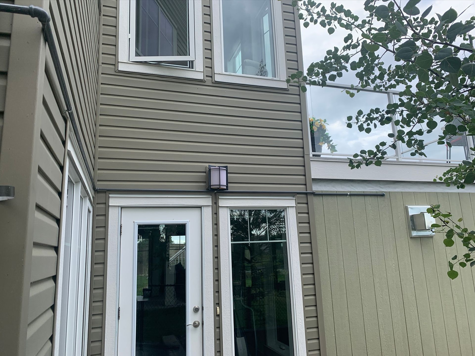 A house with a lot of windows and a door