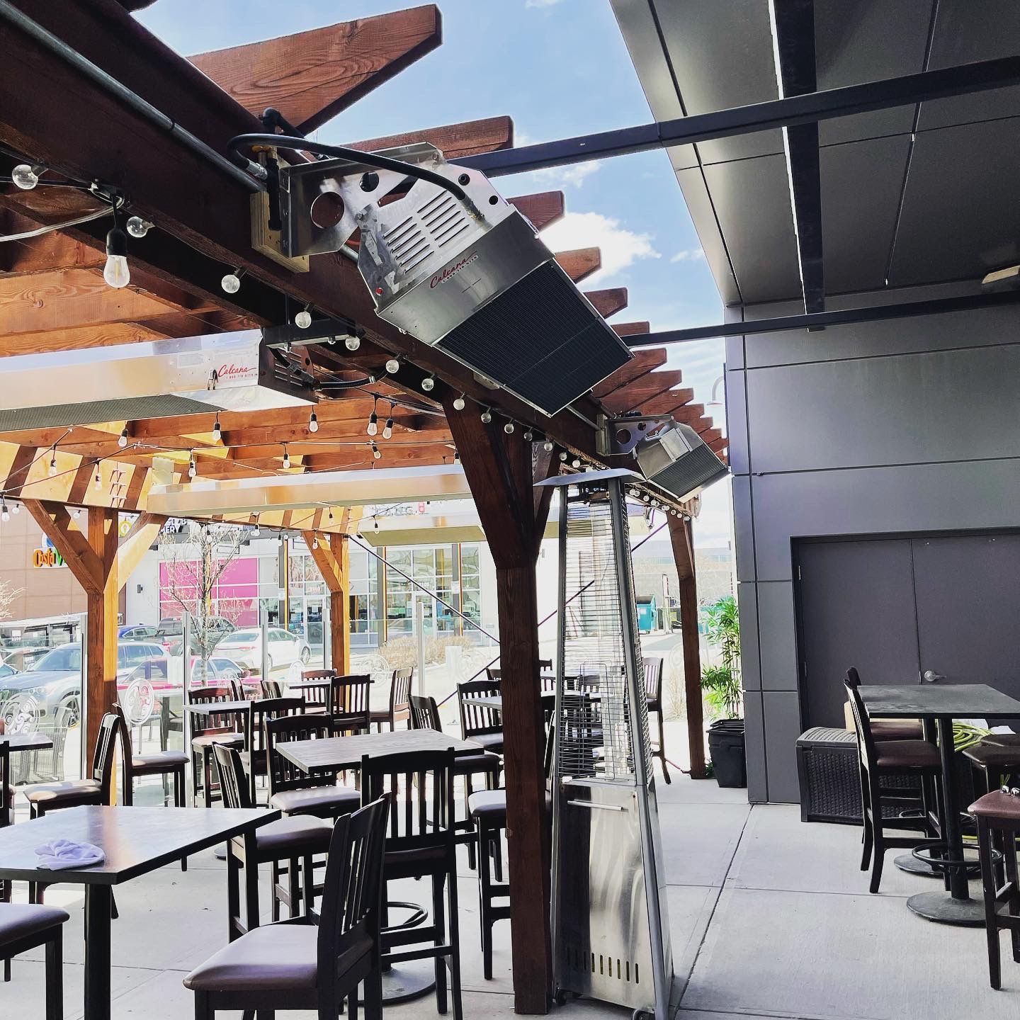A restaurant with tables and chairs under a pergola
