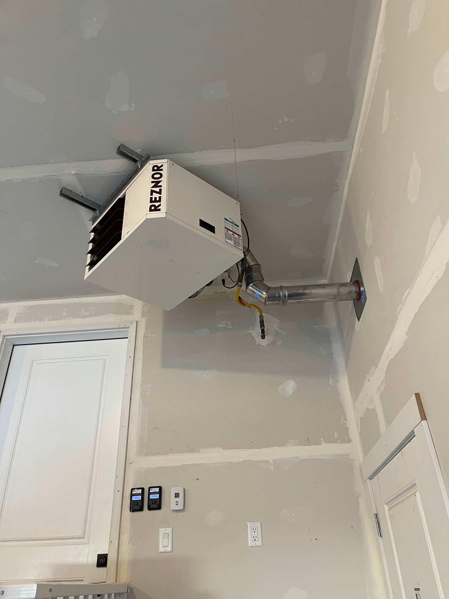 A white box with the word remix on it is hanging from the ceiling of a room.
