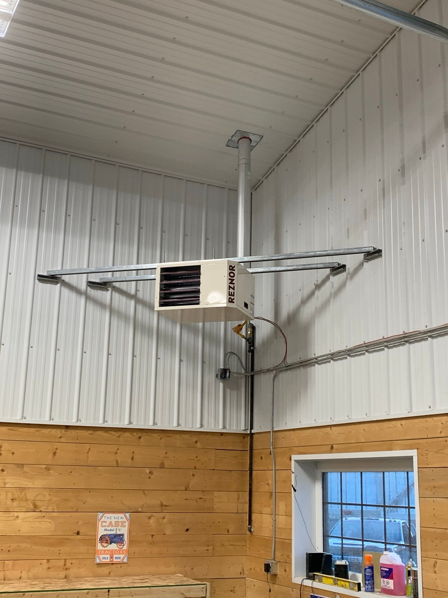 A heater is hanging from the ceiling of a building