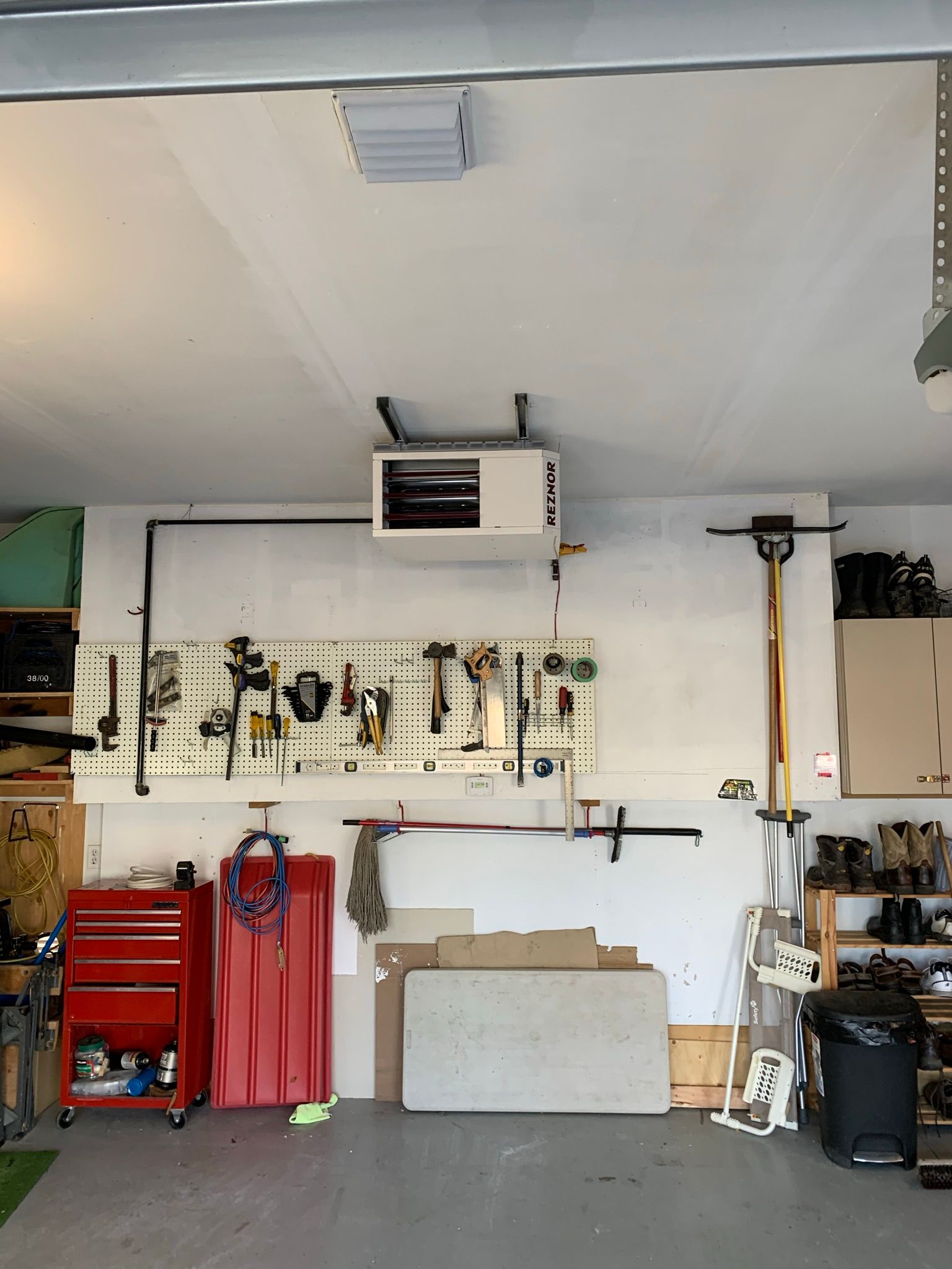 A garage with a lot of tools hanging on the wall