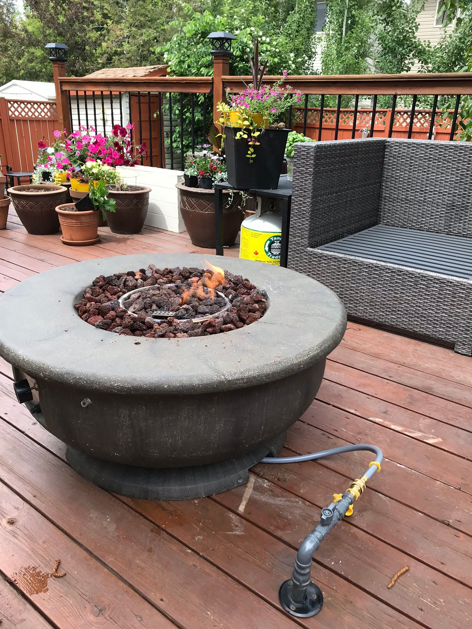 A fire pit is sitting on top of a wooden deck.