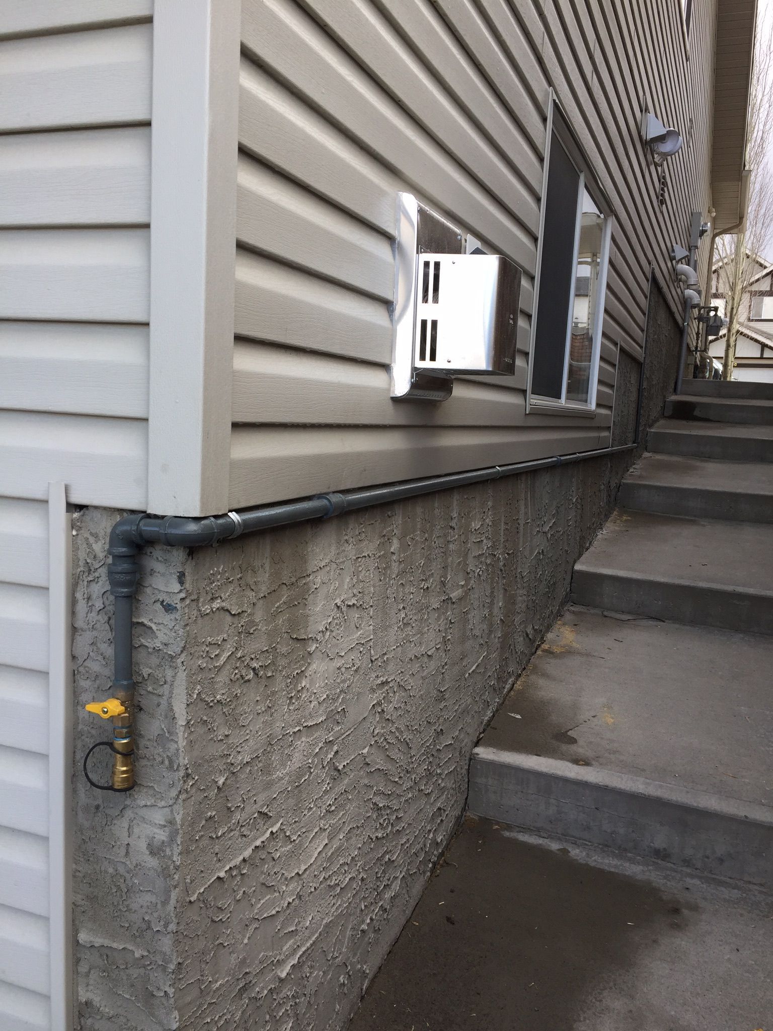 The side of a house with stairs leading up to it