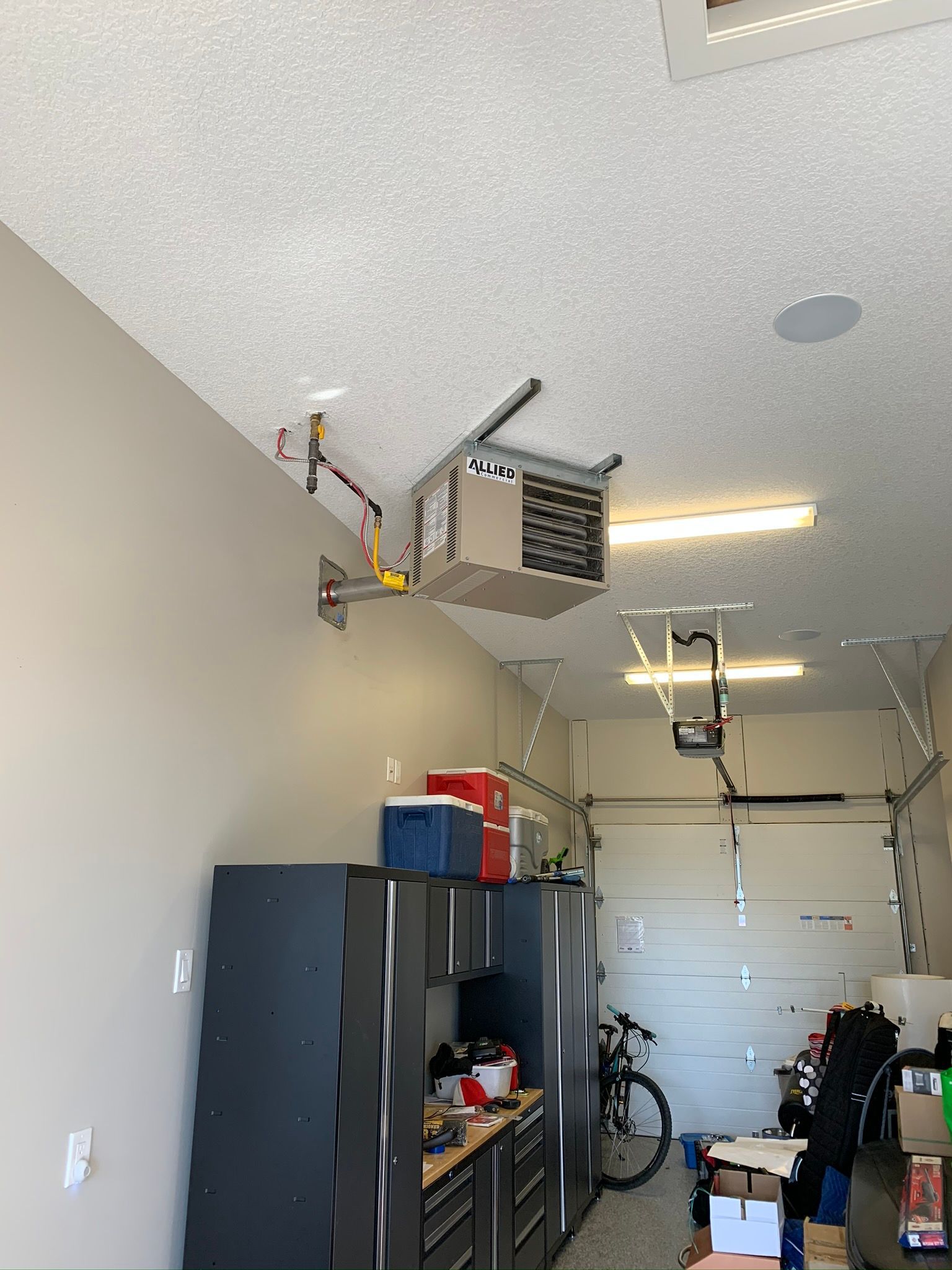 A garage with a ceiling fan and a bicycle in it.