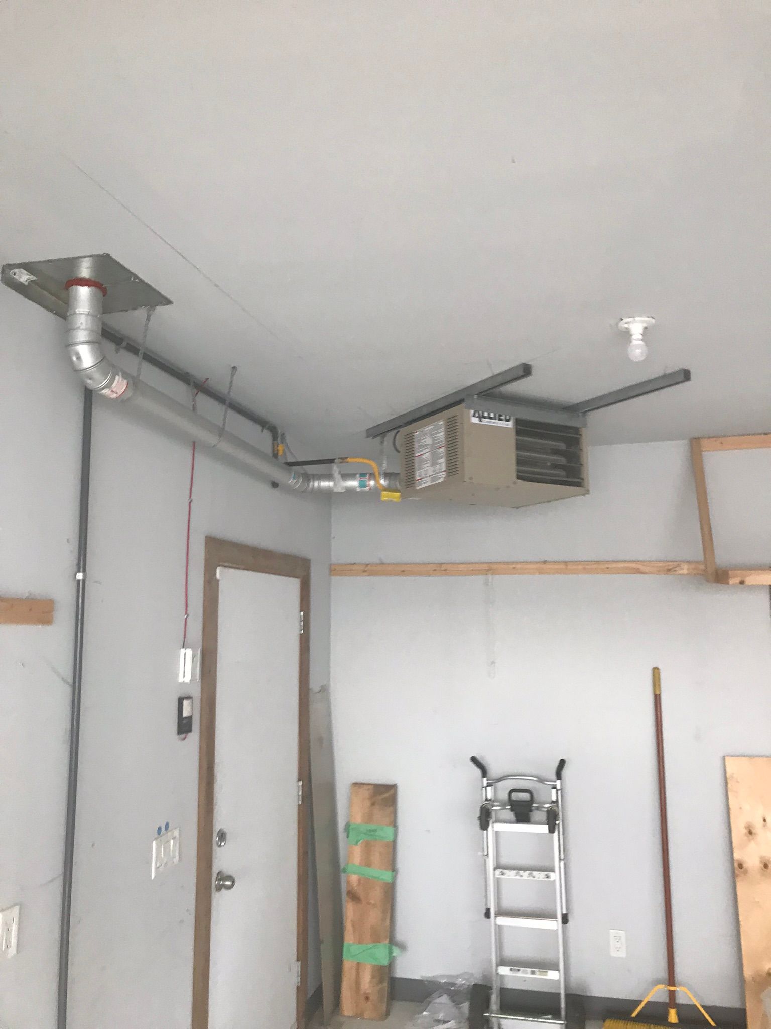A garage with a ladder hanging from the ceiling