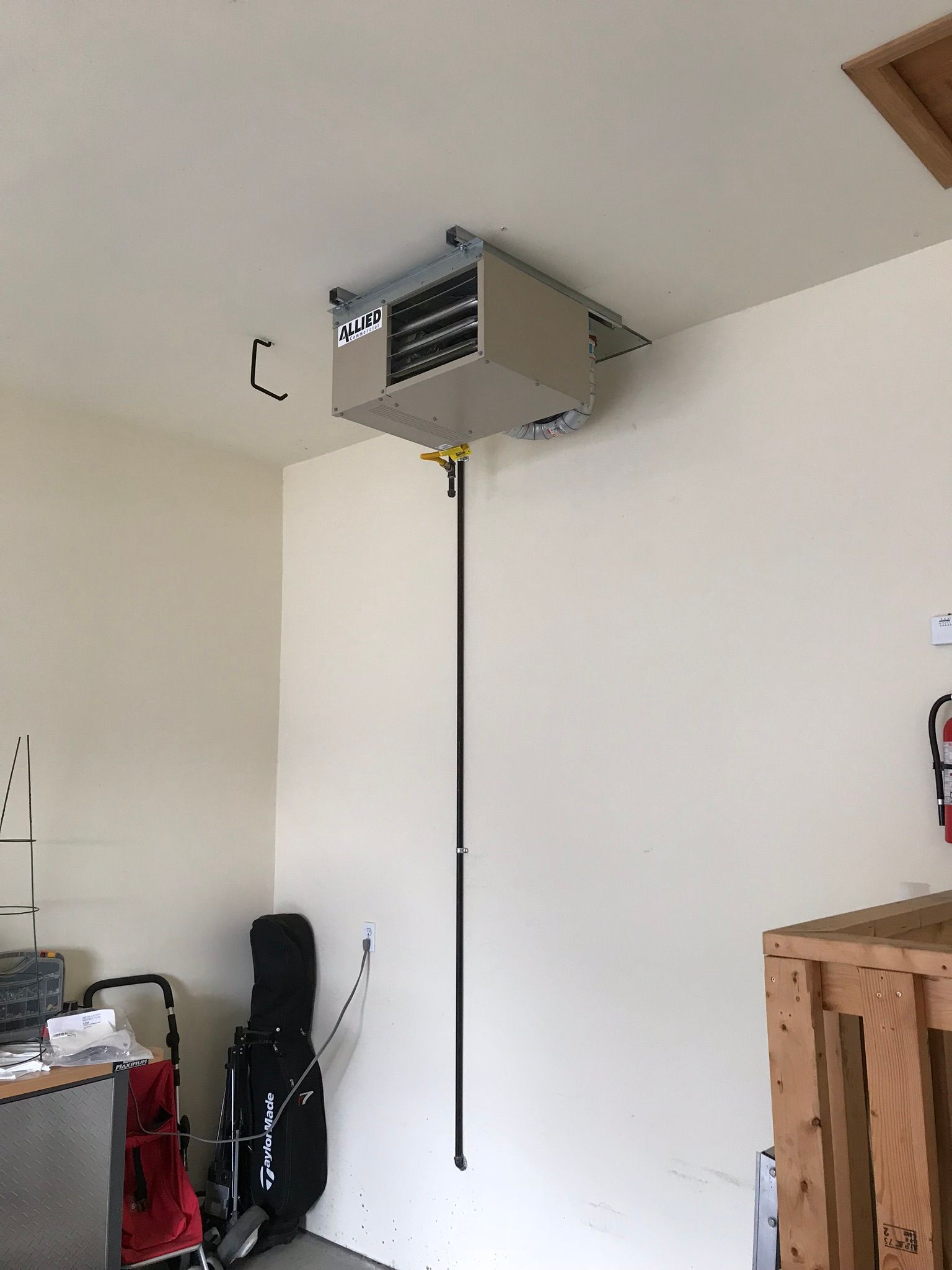 A ceiling fan is hanging from the ceiling of a garage.