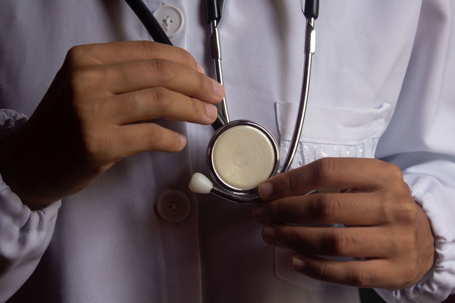 Doctor holding a stethoscope against a white coat