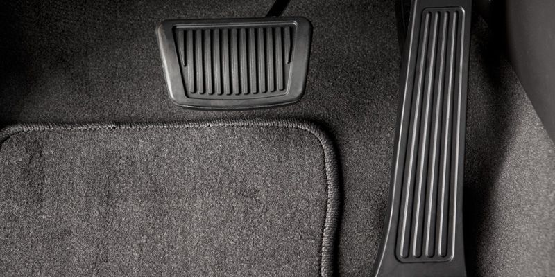 A close up of a brake pedal in a car.