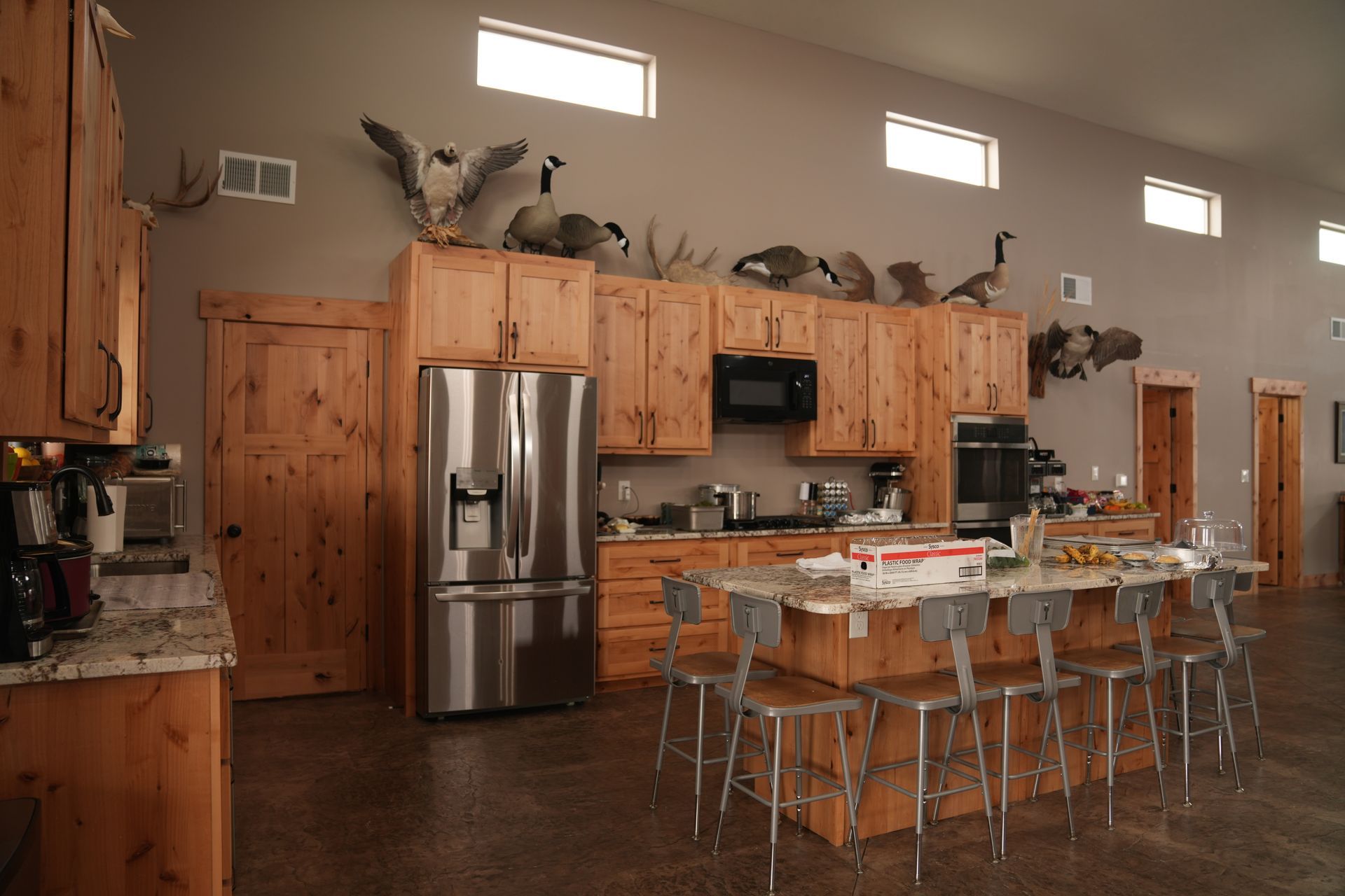 A large kitchen with wooden cabinets and stainless steel appliances