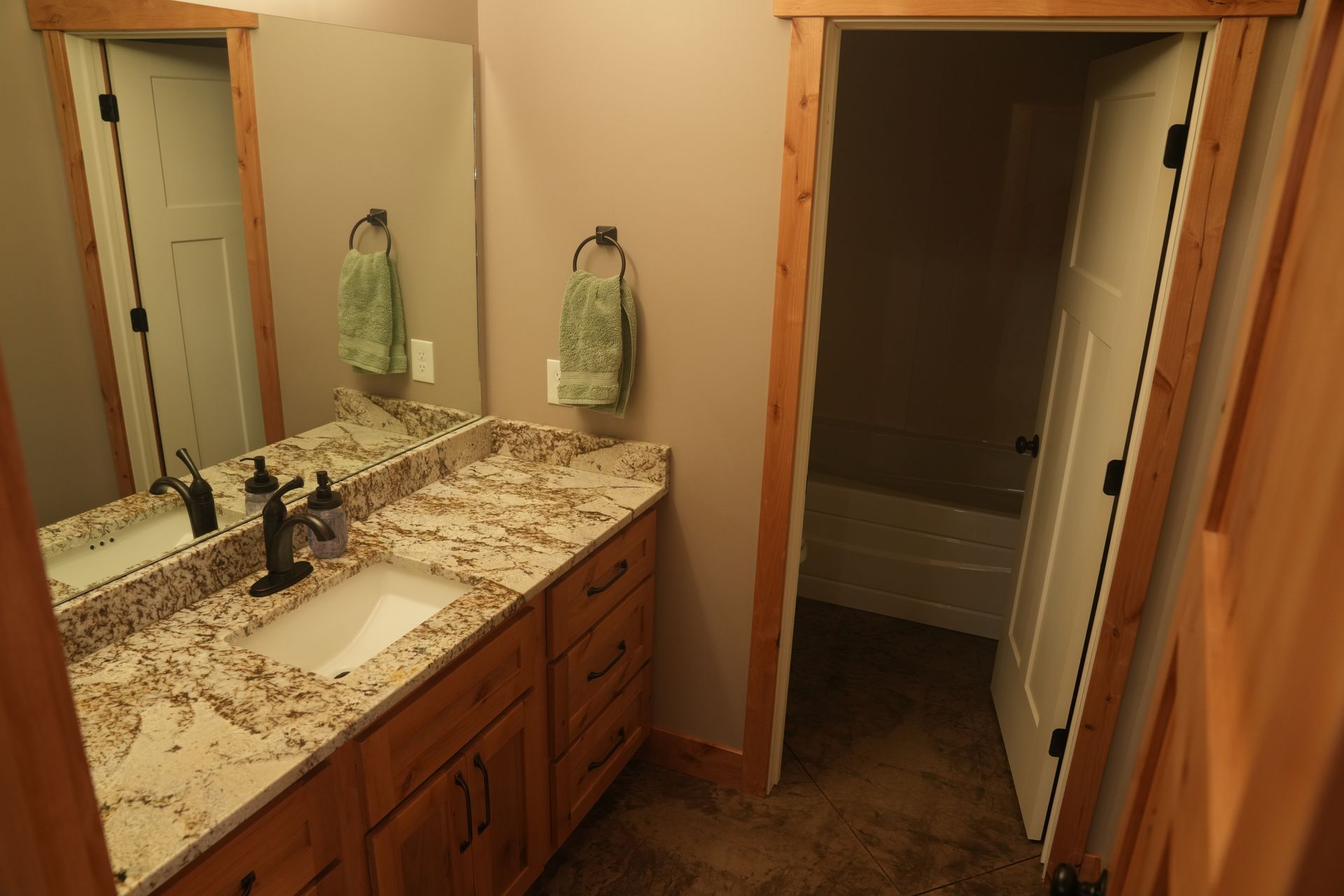 A bathroom with two sinks and a large mirror