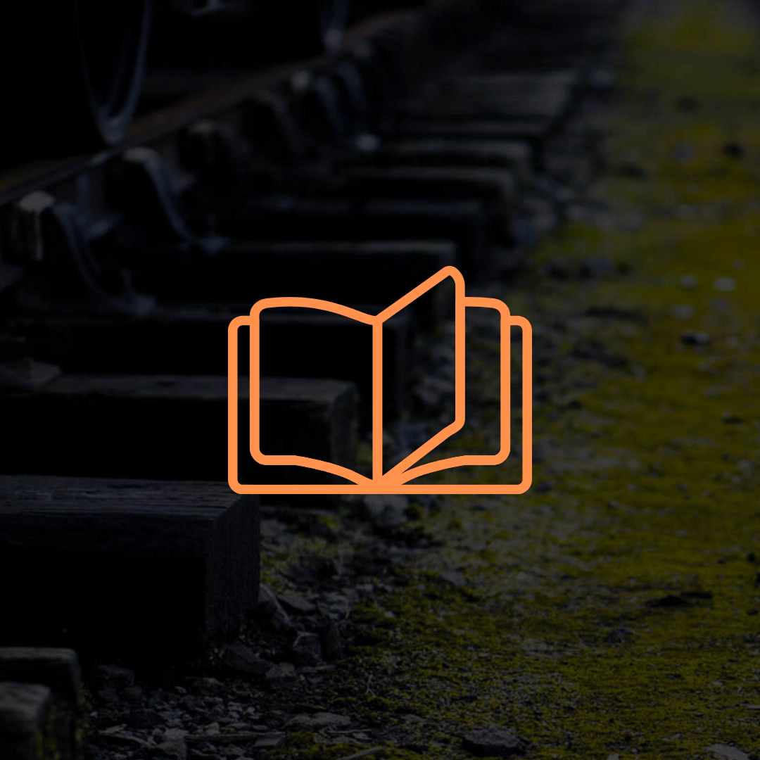 A book is sitting on top of a row of train tracks.