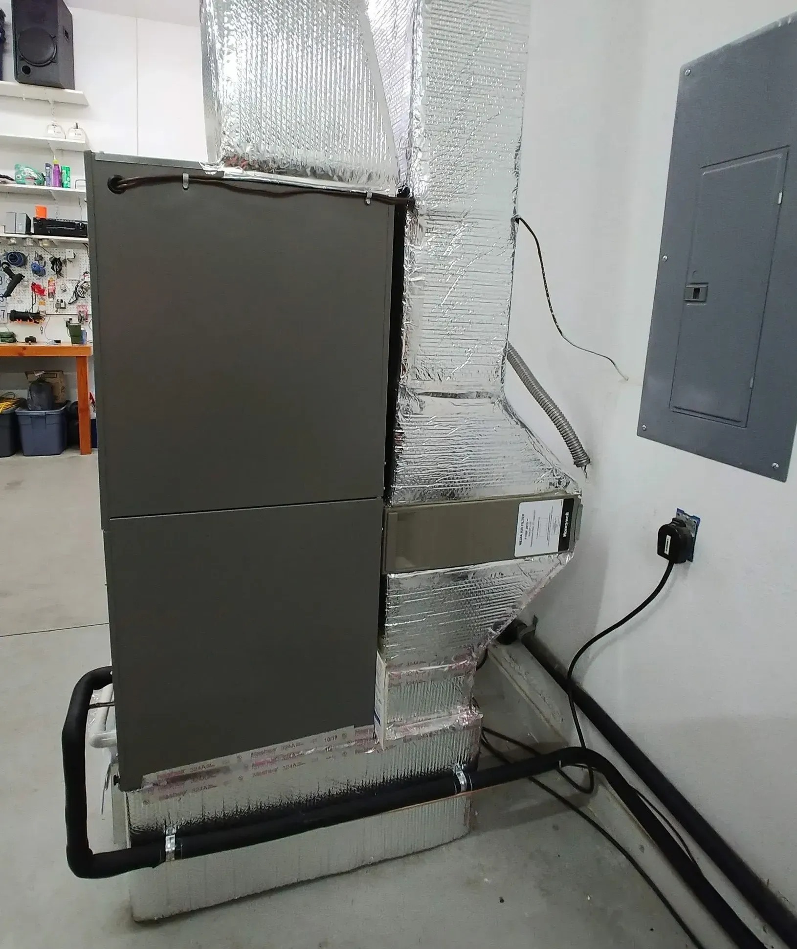 A refrigerator is sitting in a room next to a wall.