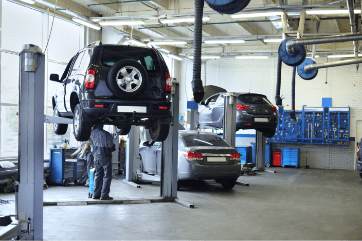 A man is working on a car in a garage.