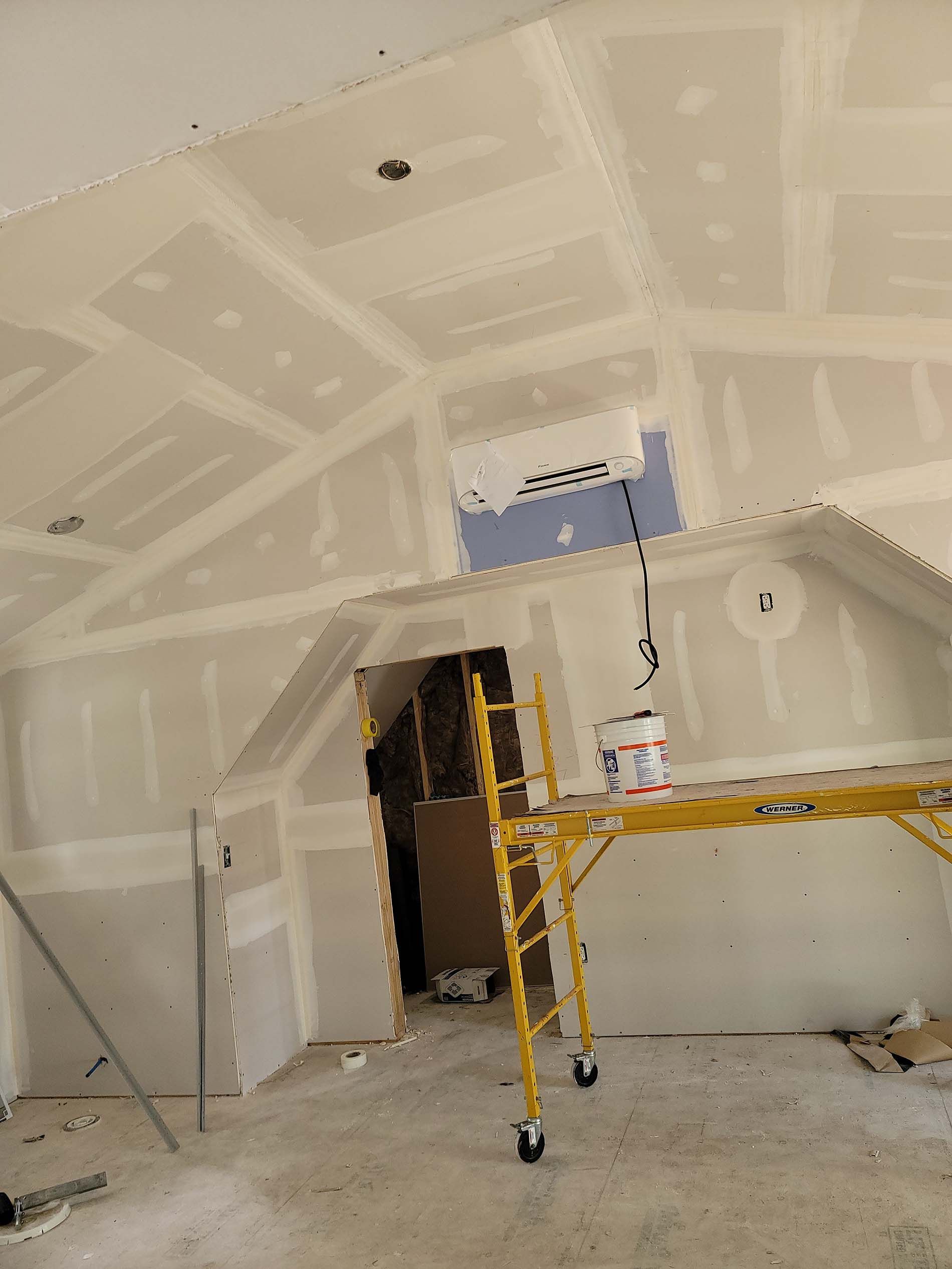 A room with a scaffolding in the middle of it.