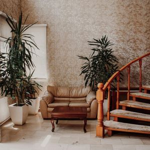 A living room with a couch a table and stairs