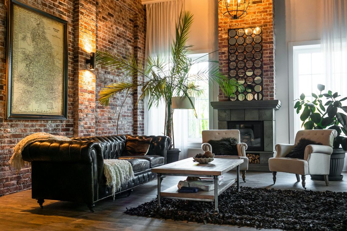 A living room with a couch , chair , coffee table and fireplace.