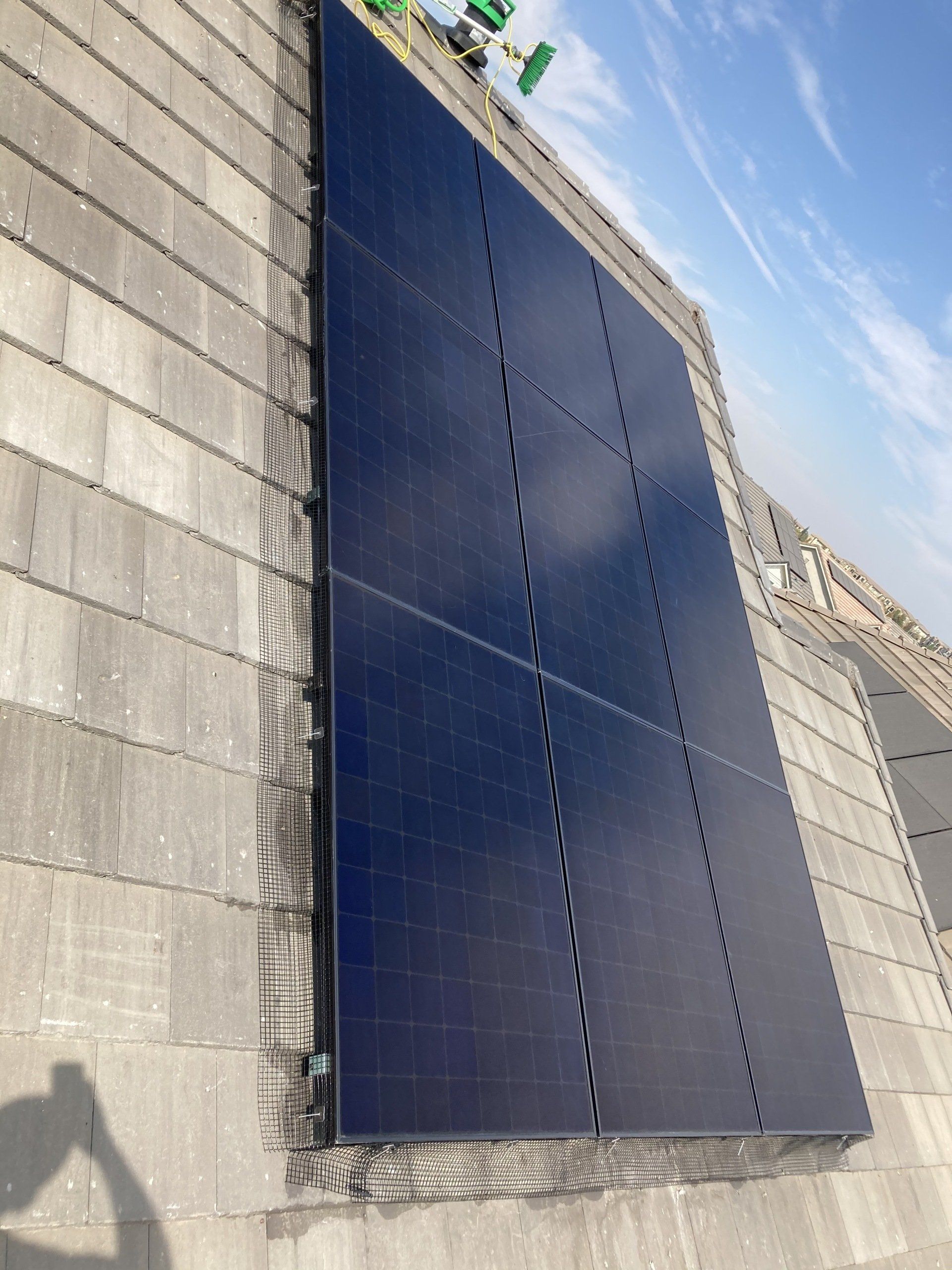 A row of solar panels on a brick wall