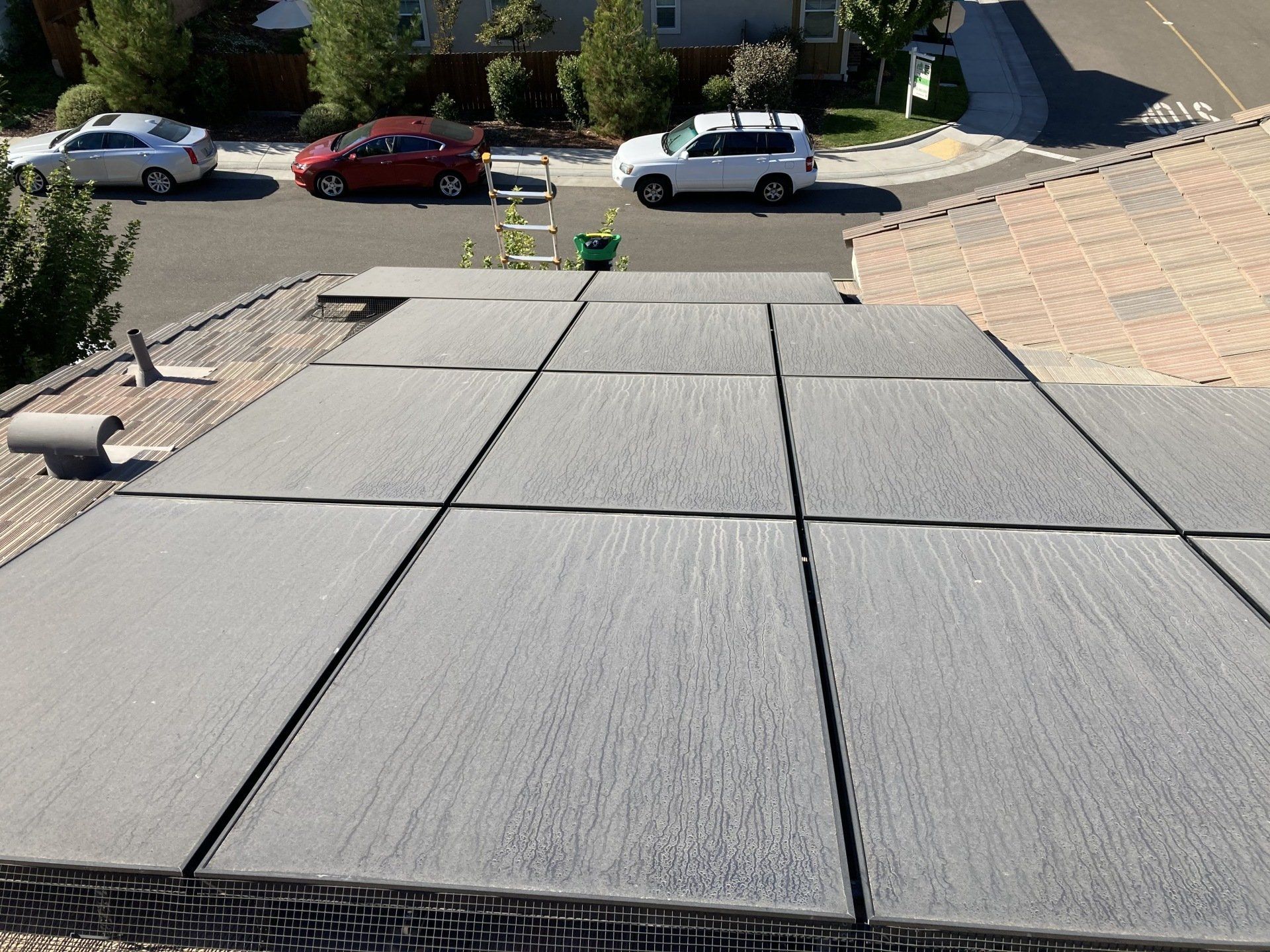 A white van is parked on the roof of a house