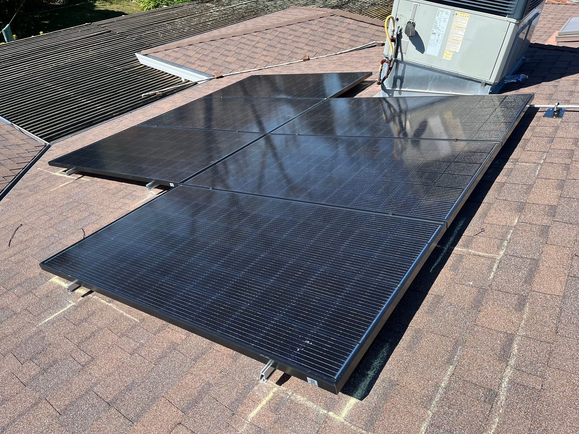 A bunch of solar panels are sitting on top of a roof.