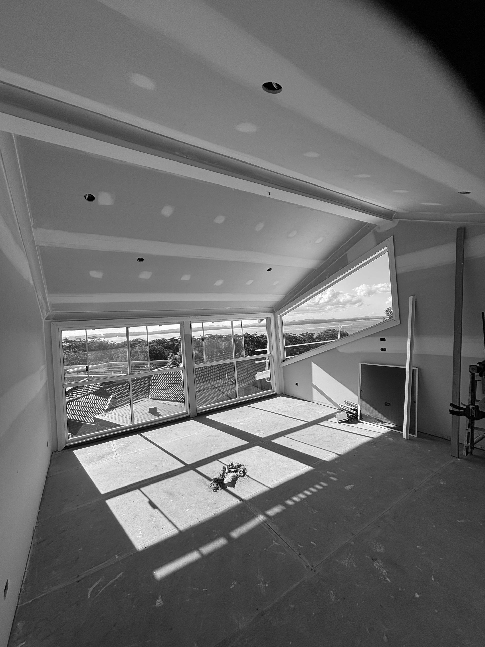 A Black And White Photo Of An Empty Room With A Lot Of Windows — MC Plastering In Fingal Bay, NSW