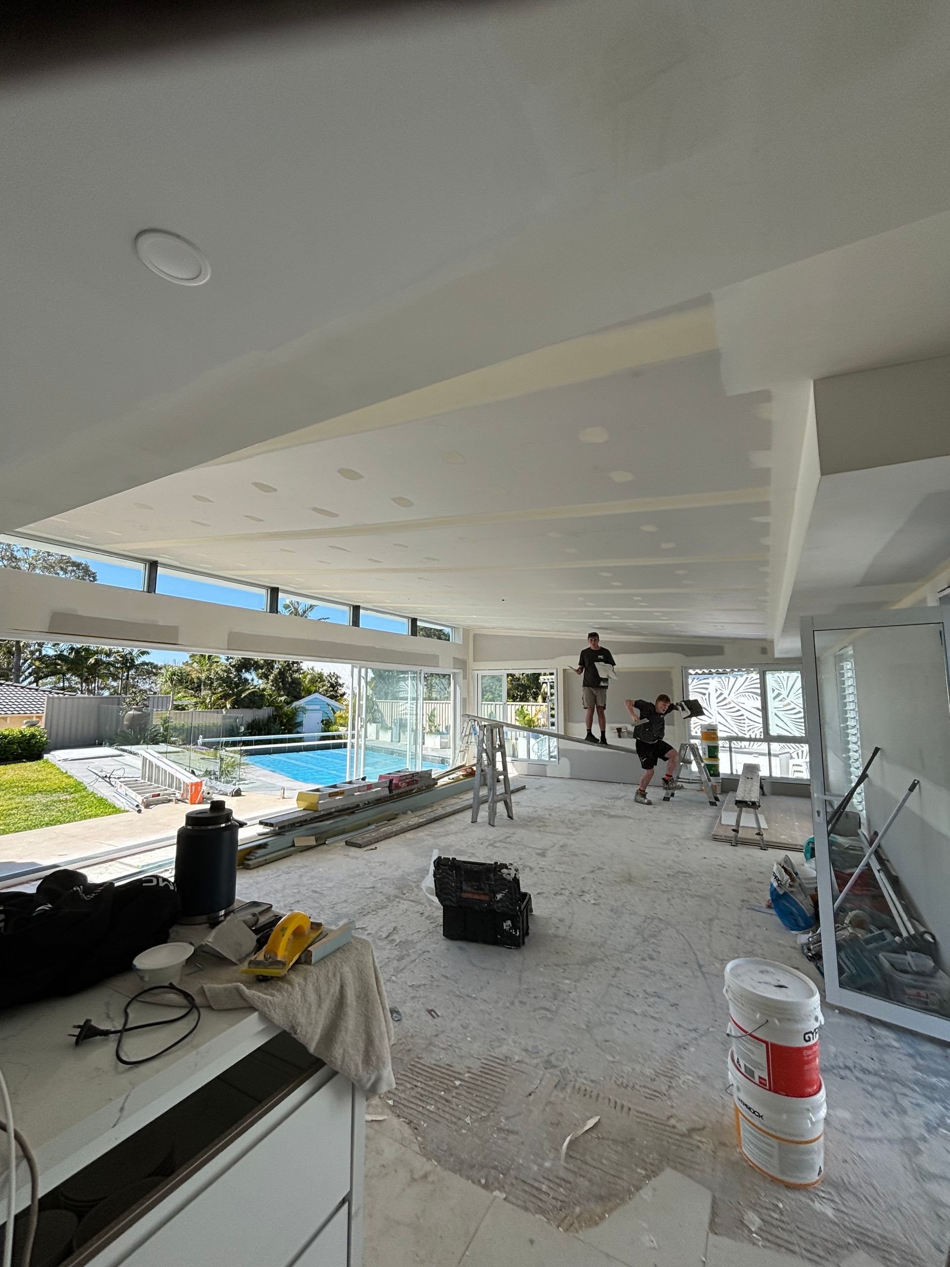 A large room with a lot of windows is being remodeled — MC Plastering In Fingal Bay, NSW