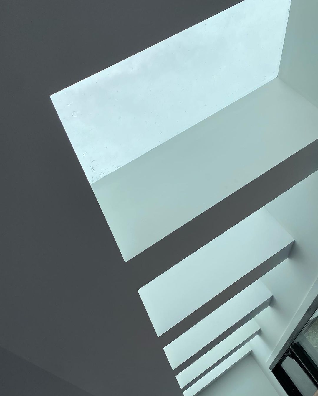 Looking Up At A Staircase With A Skylight In The Ceiling — MC Plastering In Raymond Terrace, NSW