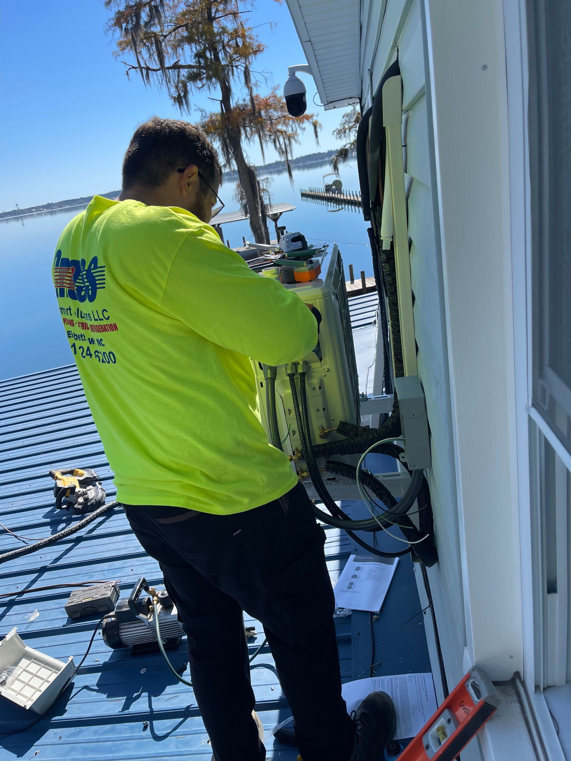 A man in a neon yellow shirt is working on a building