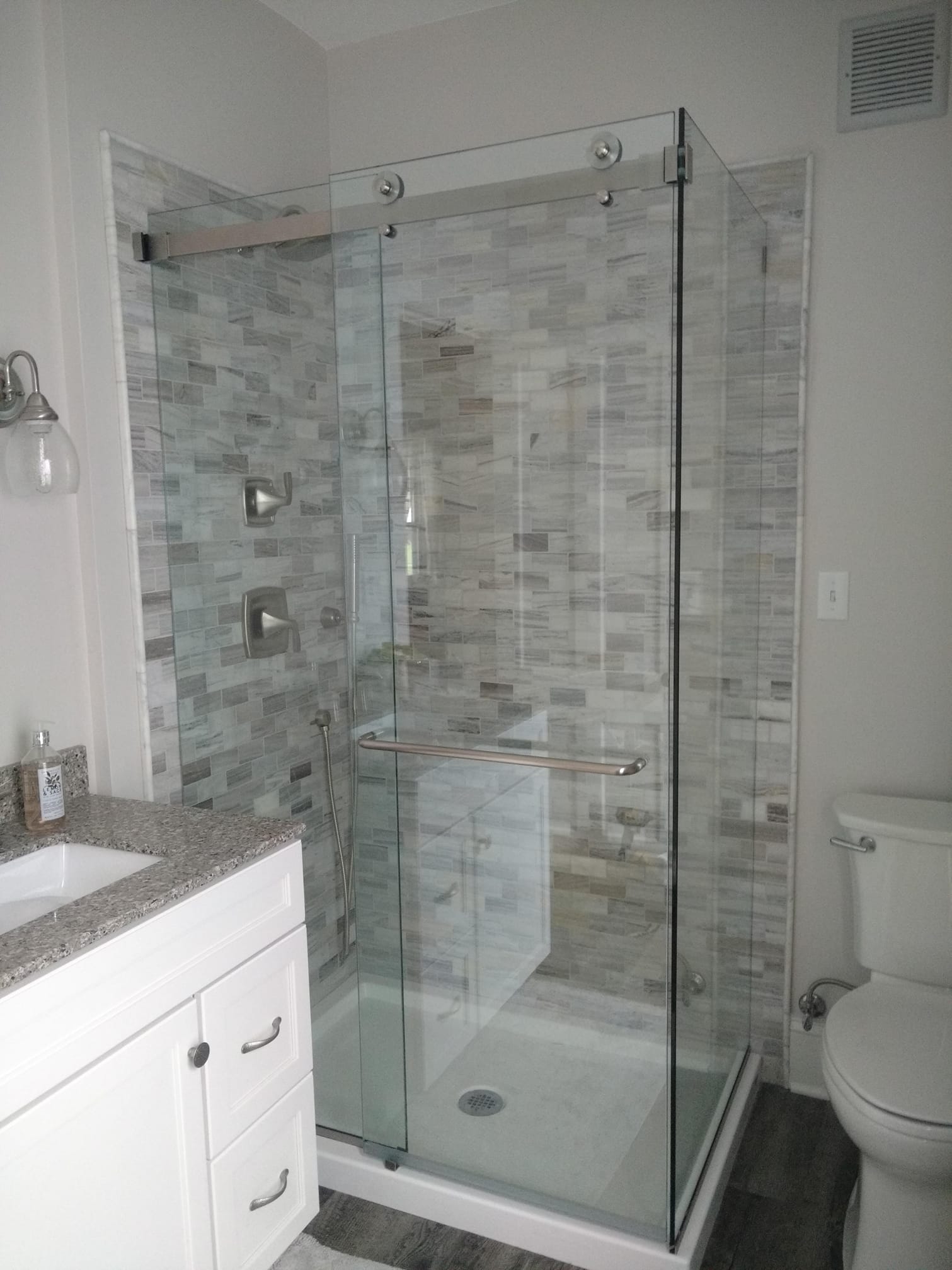 Frameless Shower Door and White Bathroom Cabinetry