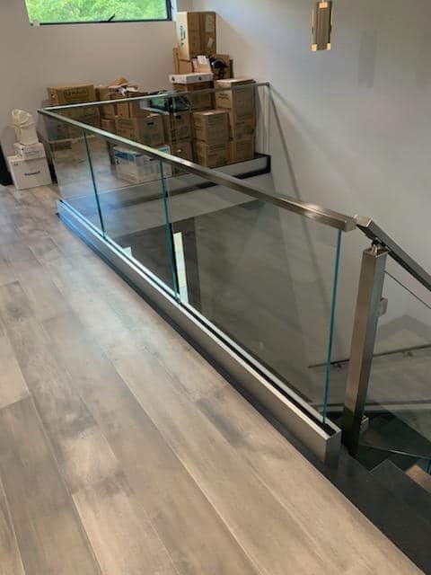 Glass Panels and Metal Railing Bordering Commercial Hallway