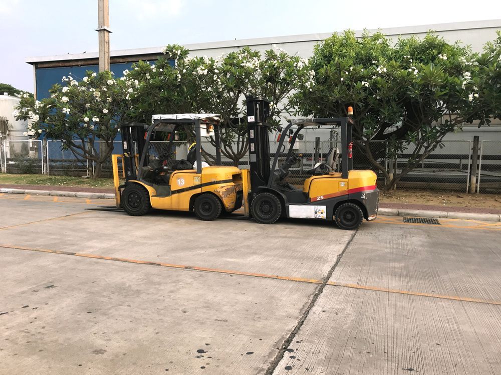 Two Yellow Forklifts Parked Side by Side — Forklift Repairs & Spares In Maryborough, QLD