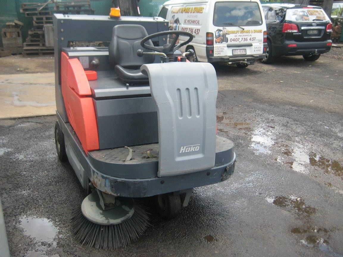 Ride-on Street Sweeper in a Parking Lot With Parked Vehicles — Forklift Repairs & Spares In Svensson Heights, QLD