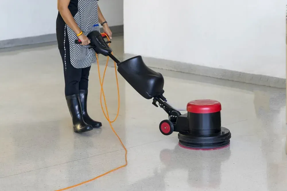 Person Using A Floor Polishing Machine On A Shiny Indoor Floor — Forklift Repairs & Spares In Maryborough, QLD