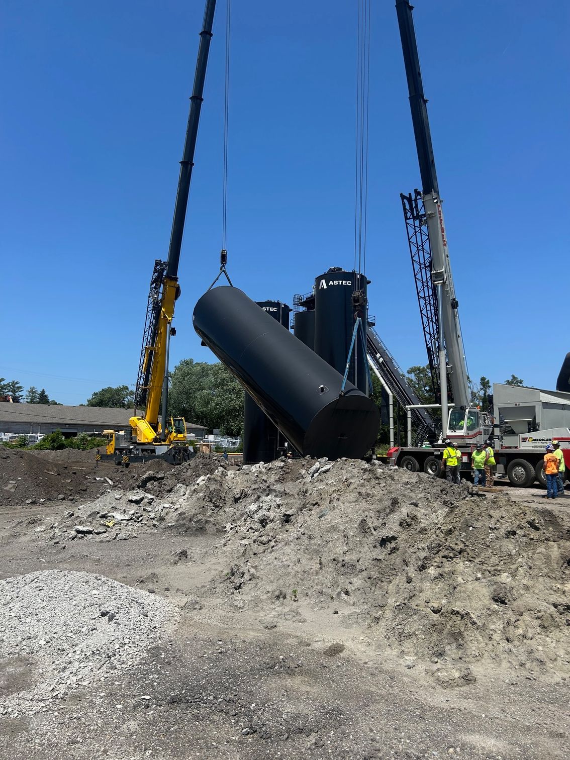 A large machine, partially on a forklift, damaged in a fire inside a warehouse.