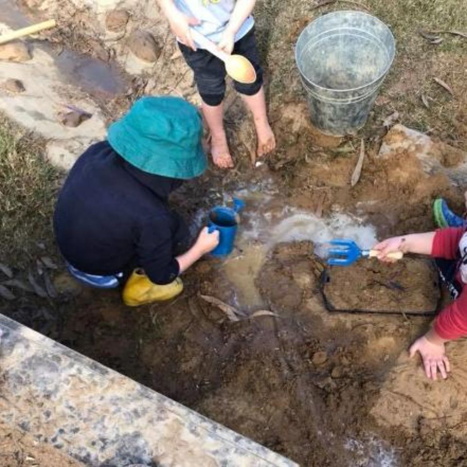 kids watering plant