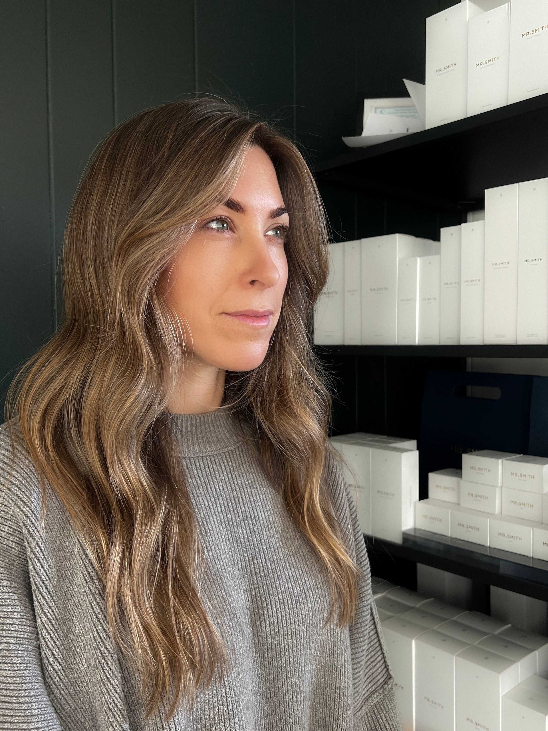 Brown wavy haircut Boone NC with products in background