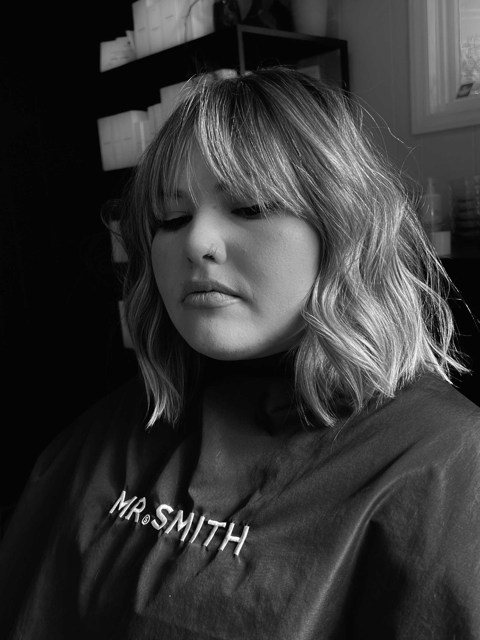 woman in salon chair with blonde new haircut Boone NC
