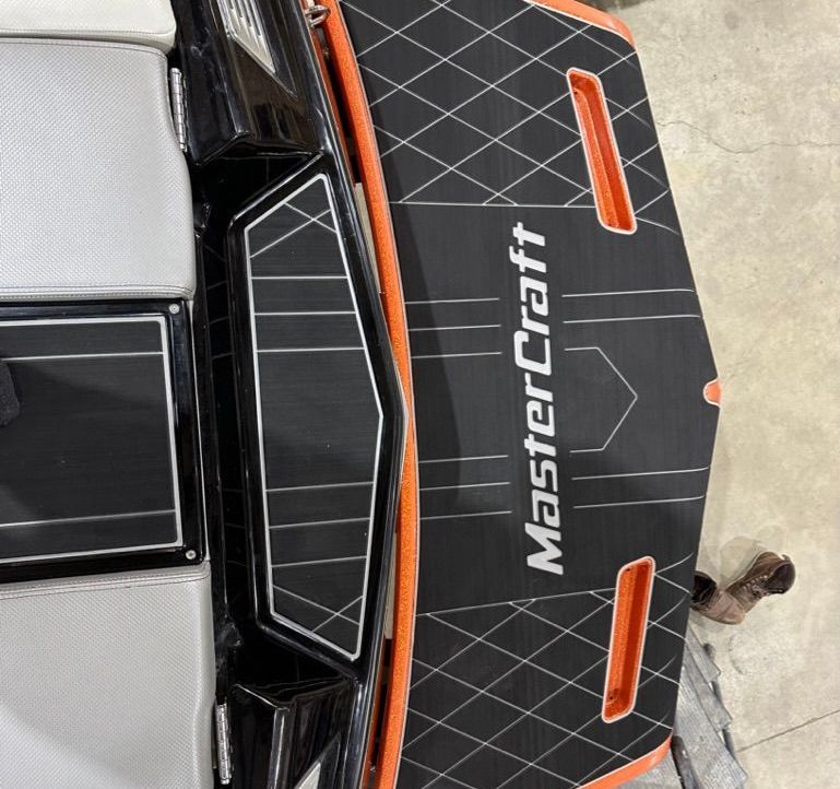 A mastercraft boat is sitting on a cement floor