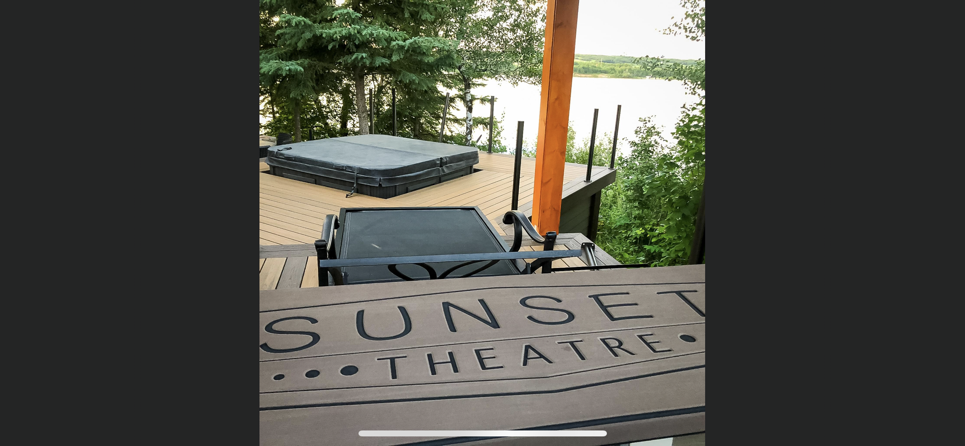 A sign for the sunset theatre with a stage in the background