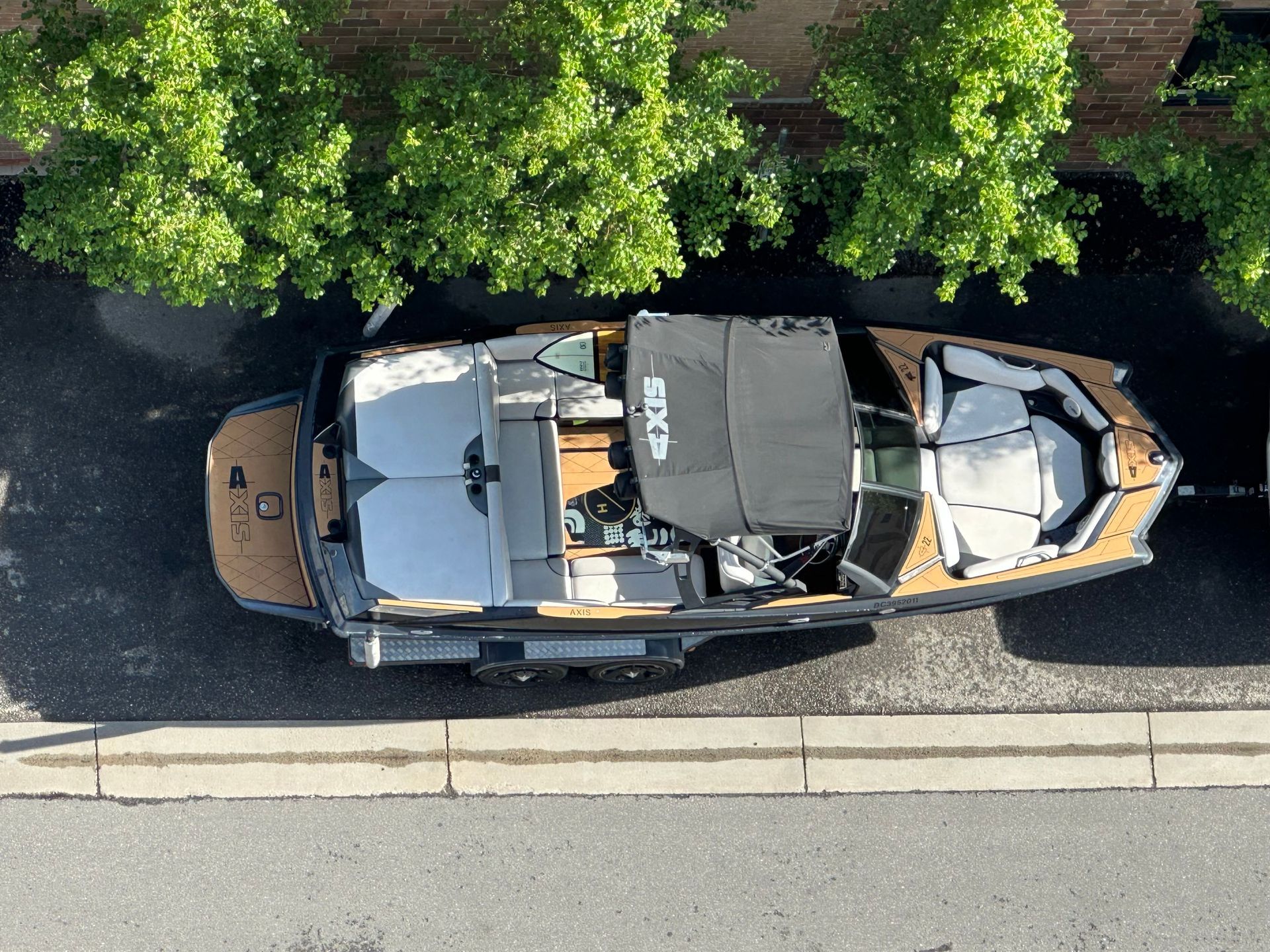 An aerial view of a boat parked on the side of the road
