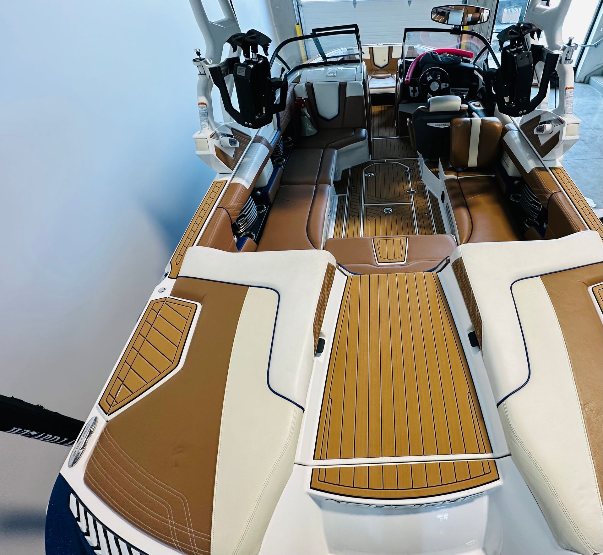 A white and brown boat with a wooden deck