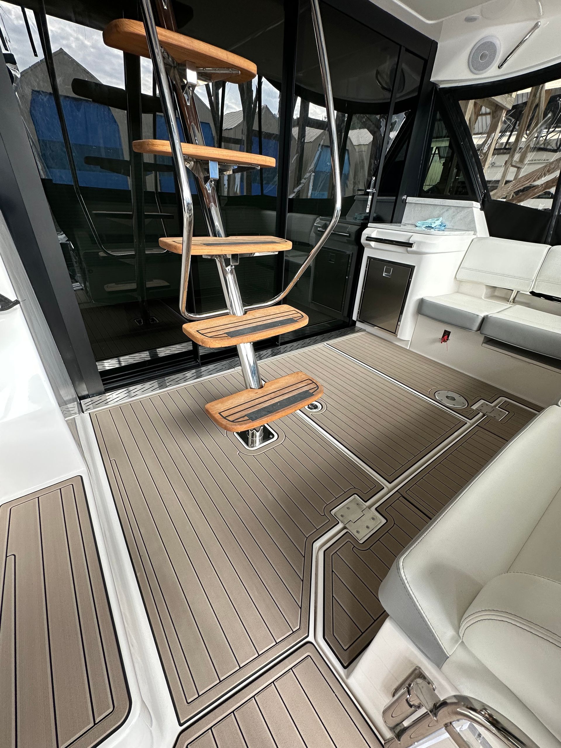The inside of a boat with stairs leading up to the deck.