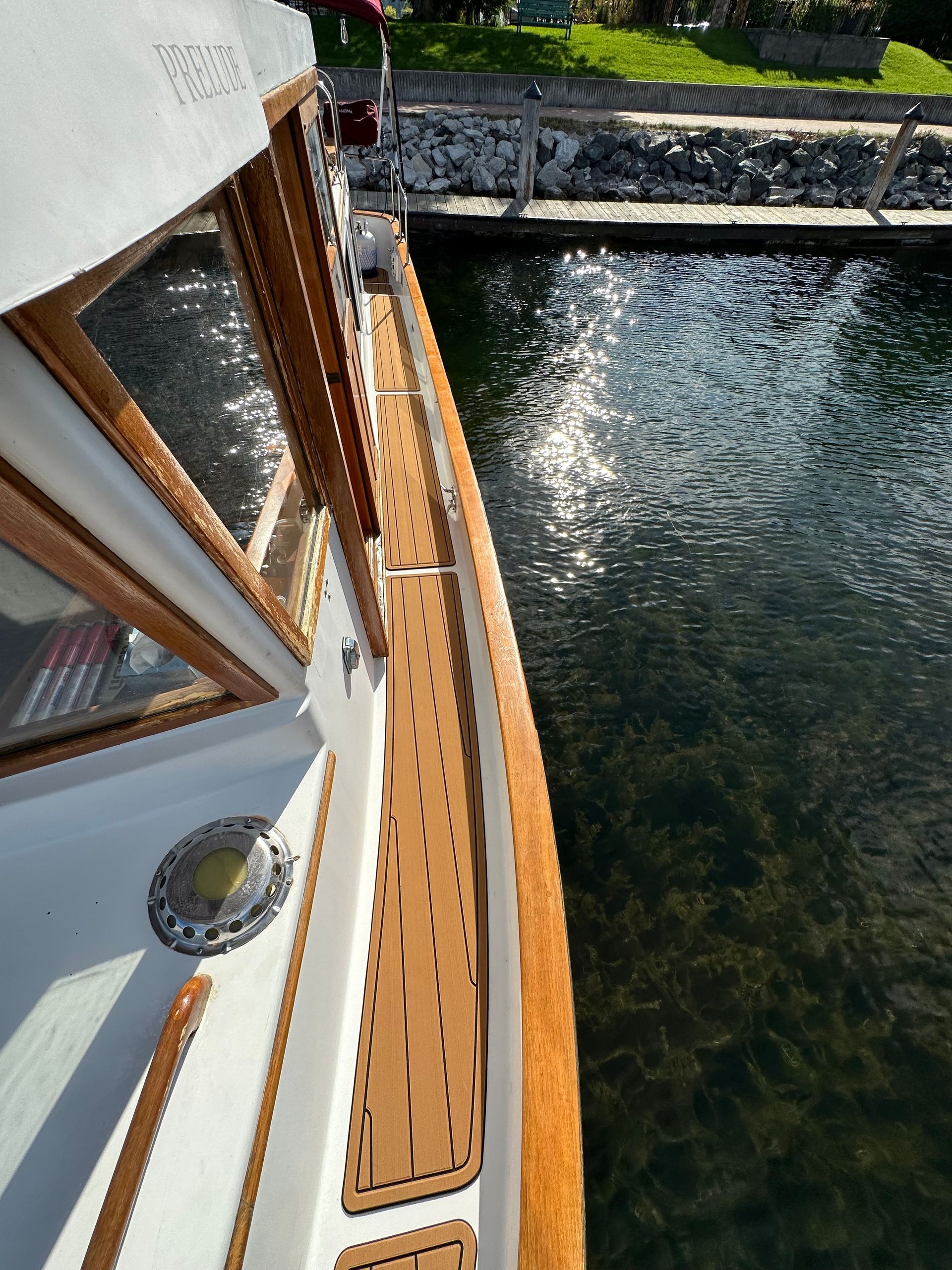 A boat with a wooden deck is in the water