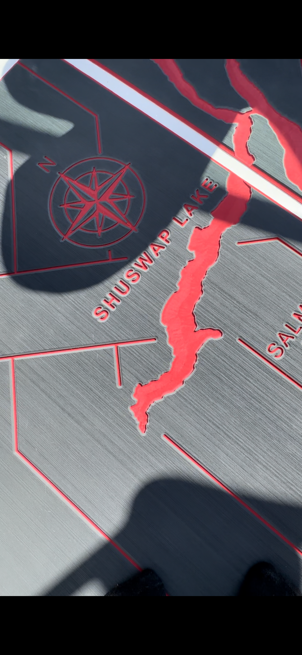 A shadow is cast on a map of the Shuswaps