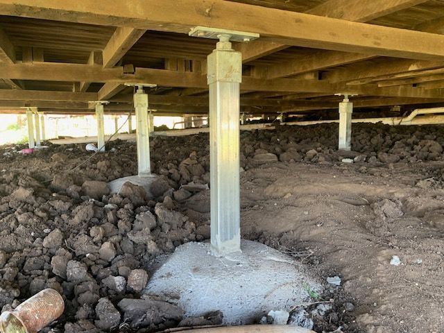 The foundation of a house with a lot of dirt underneath it.