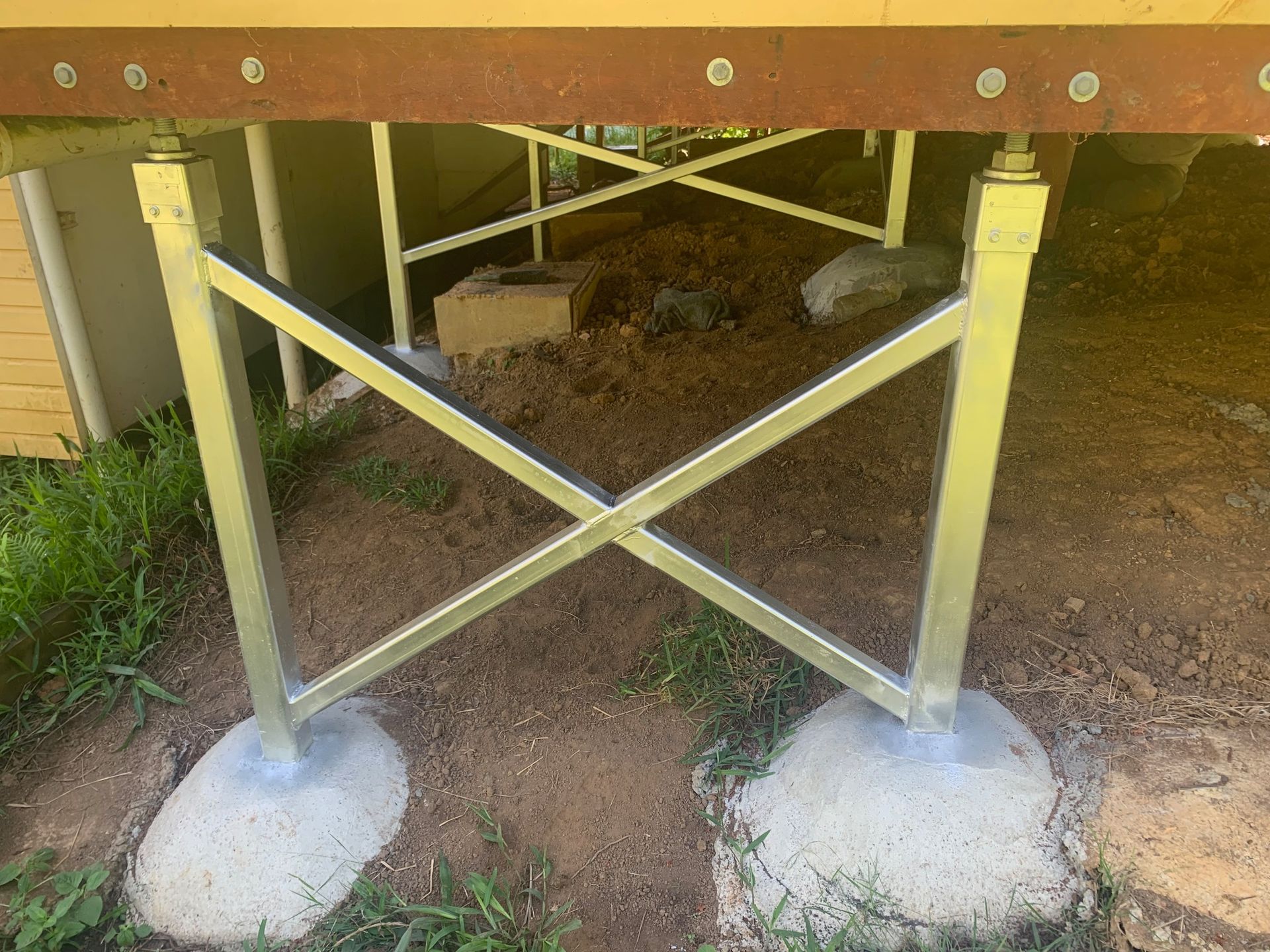 A metal structure is sitting on top of a concrete base.