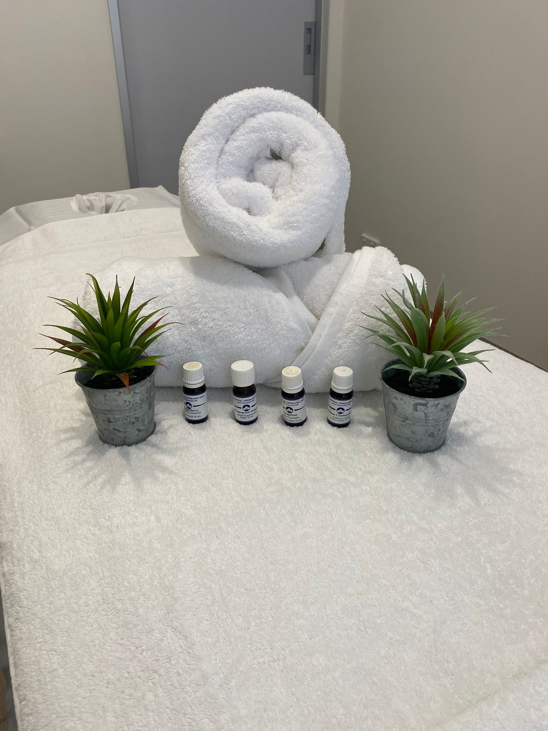 a massage table with towels and essential oils on it